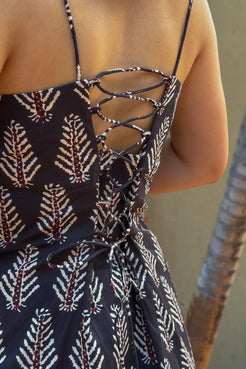 Dress with leaf pattern and thin straps on a neutral background
