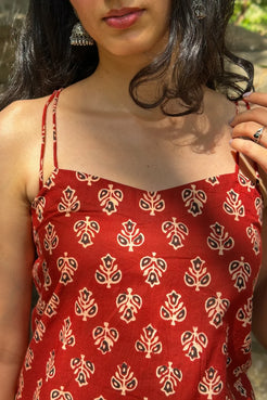 Person wearing a butta patterned top with blurred background
