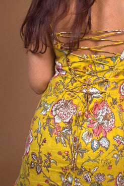 Jal-Yellow floral dress with a strapless design on a brown background