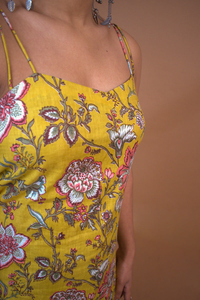 Jal-Yellow floral dress with thin straps on a brown background