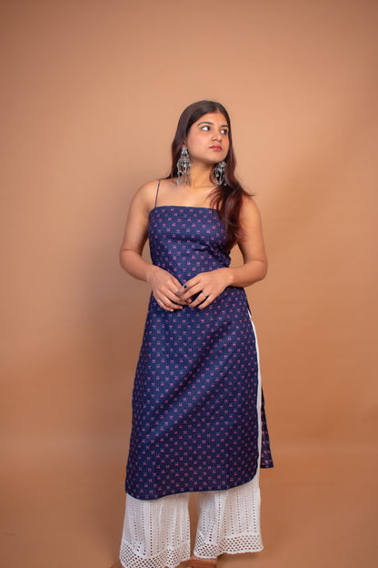 Woman wearing a jiva-blue dress with white lace hem on a brown background