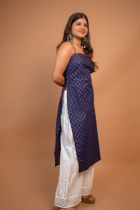 Woman wearing a jiva-blue traditional outfit on a brown background