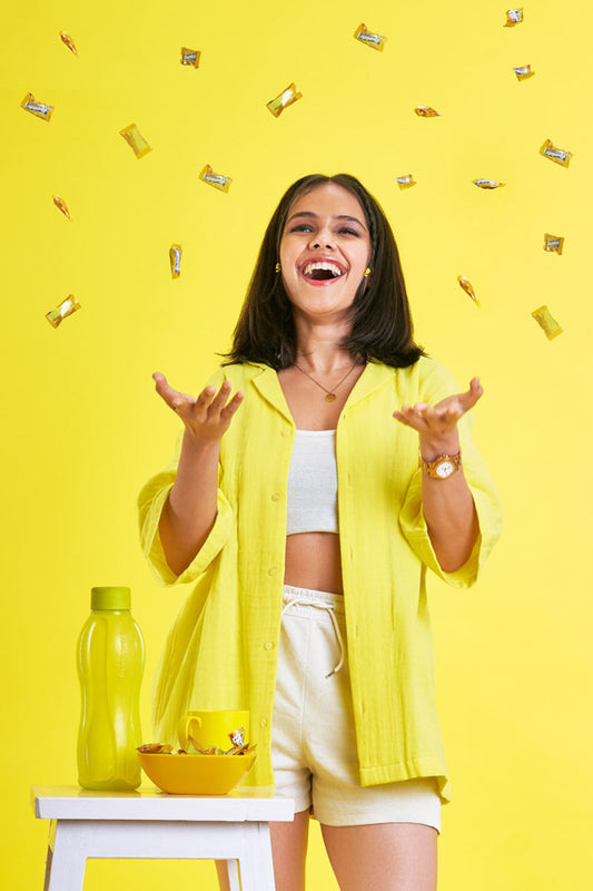 Girl wearing an oversized yellow unisex shirt 