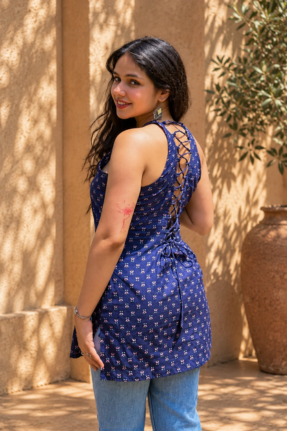 Jiva-blue dress with pink floral pattern worn by a person, standing outdoors.