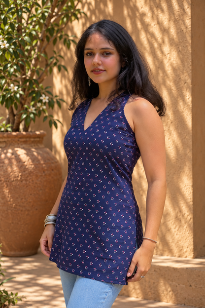 Jiva-blue dress with pink floral pattern worn by a person, standing outdoors.