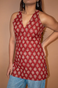 butta Red patterned sleeveless top worn by a person on a beige background