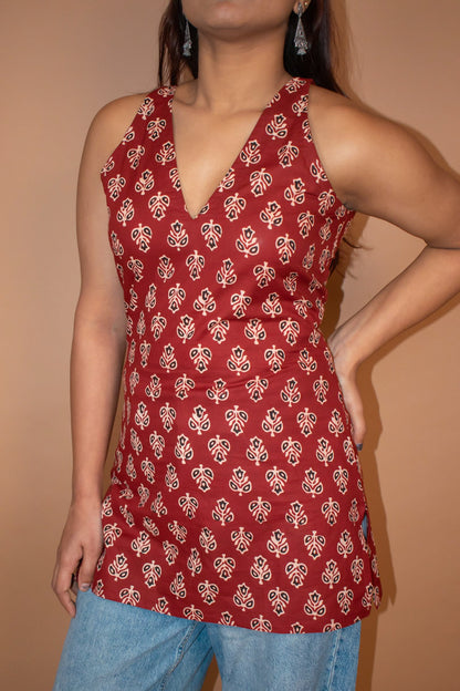 butta Red patterned sleeveless top worn by a person on a beige background